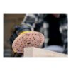 Close-up of hand sander and sanding disc