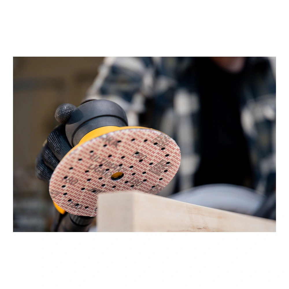 Close-up of hand sander and sanding disc