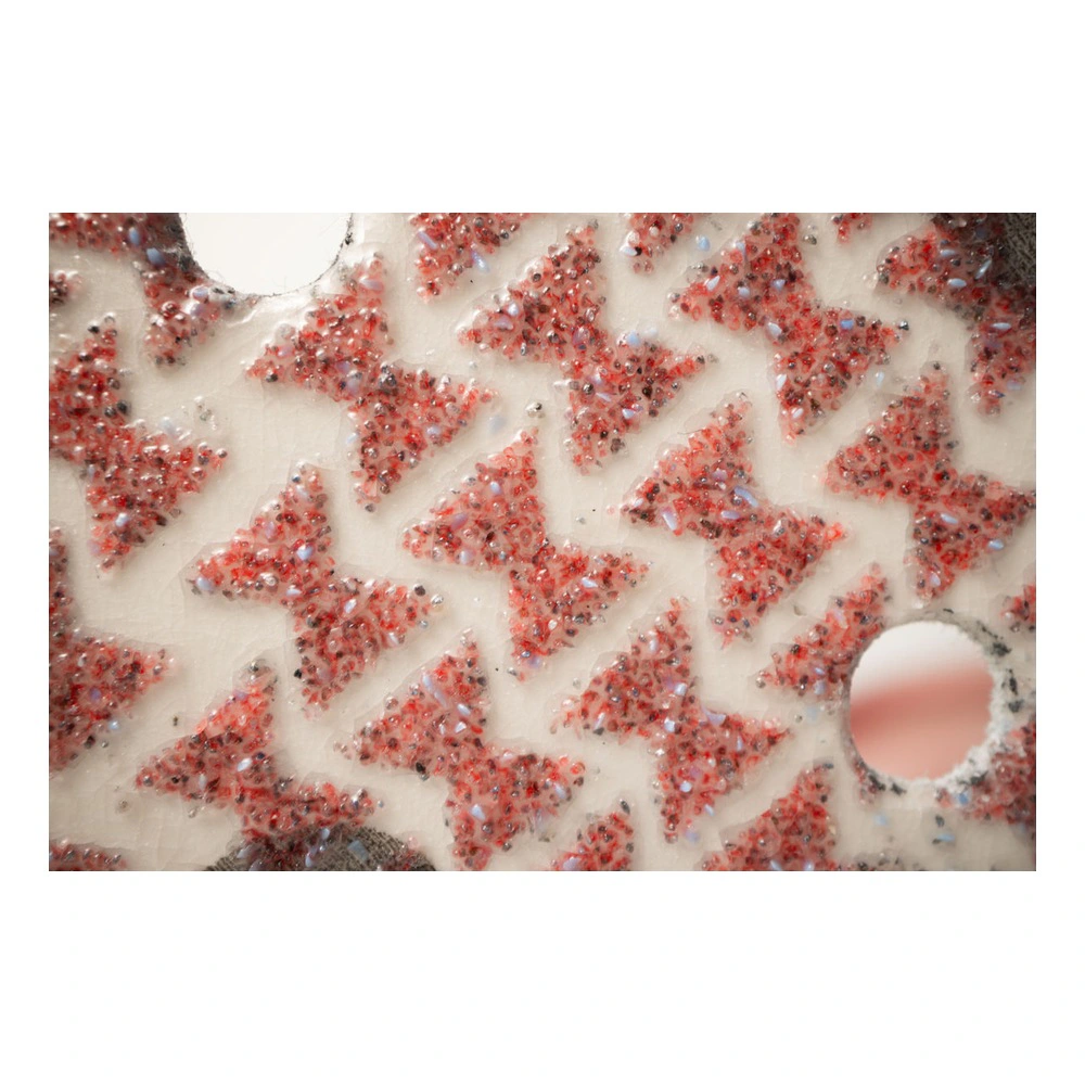 Close-up of red abrasive surface with holes