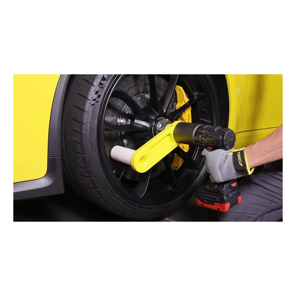 Torque wrench on black car wheel