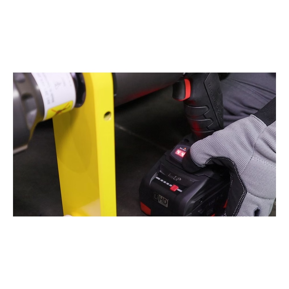Gloved hand using torque wrench on wheel