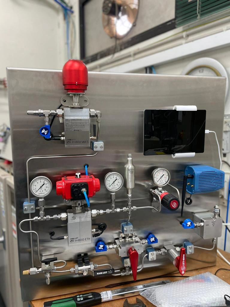 Piping and pressure gauges on a metal panel