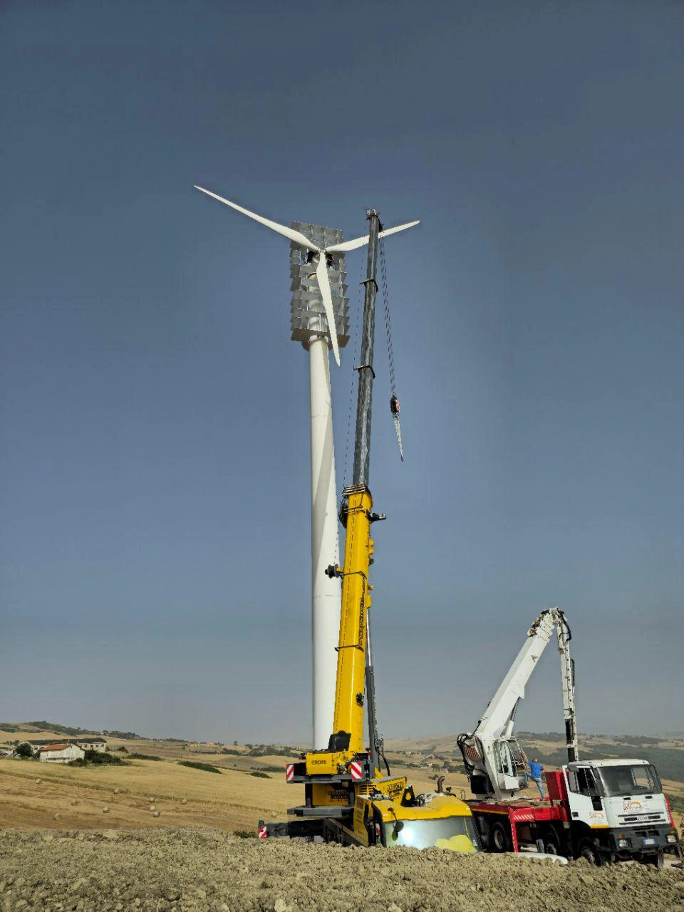 Wind turbine at a work site with lifting equipment